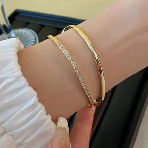 Double-layered 18K gold-plated cuff bracelet with zircon accents and a minimalist design