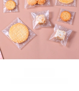 Close-up of matte self-adhesive packaging bags with white polka dots for cookies and snacks