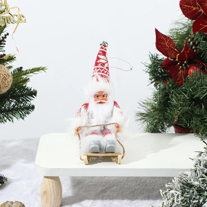 Detailed view of a Santa Claus figurine on a wooden sleigh with Nordic pattern hat