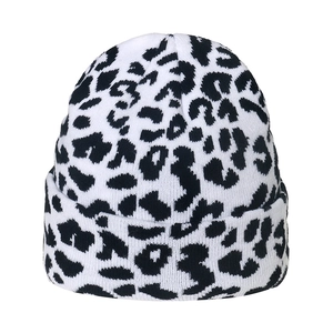 Close-up of leopard print knit beanie featuring thick texture and folded cuff detail