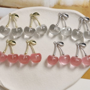 Detail view of cherry-shaped DIY pendants in translucent pink and white with metal stems