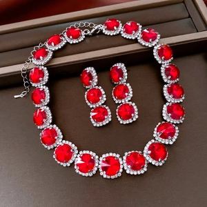 Detailed view of vintage jewelry set with red crystal necklace and matching round earrings