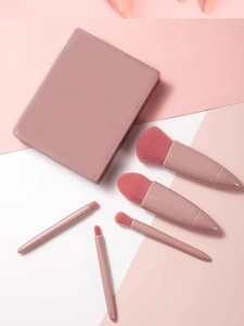 Detail view of 5-piece pink makeup brush set with a portable mirror travel case