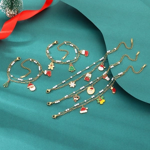 Detailed view of Christmas charms featuring Santa and reindeer on golden link chain