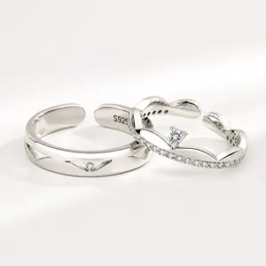 Close-up of S925 sterling silver couple rings featuring crown design and V-groove texture