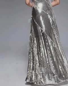 Close-up of shimmering silver sequins and tassel details on the elegant evening gown