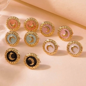 Detailed view of enamel moon stud earrings in various colors with gold hammered frames