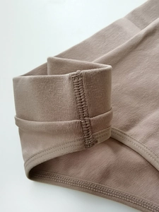 Detailed close-up of ribbed cotton underwear waistband with high elasticity stitching