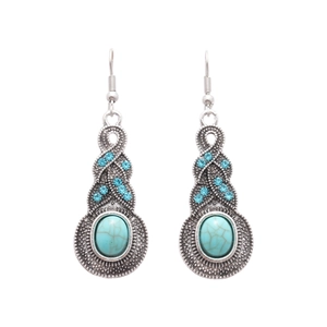 Vintage silver earrings with turquoise teardrop stones and blue rhinestones on white backdrop