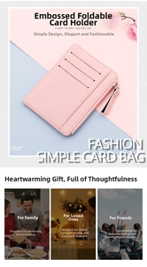 Detailed view of pink embossed leather slim card wallet with zipper and tassel charm
