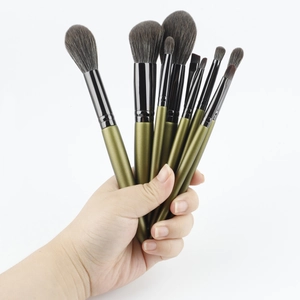 Close-up of 8-piece green makeup brush set with soft grey gradient bristles