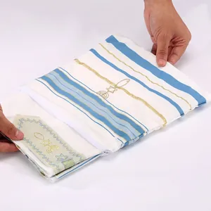Detailed close-up of a white polyester ethnic shawl featuring blue stripes and gold embroidery