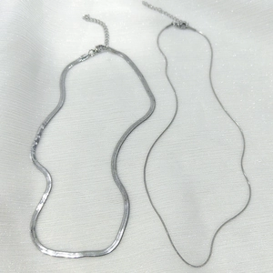Detail of silver double-layered snake chains with lobster clasps and extension links