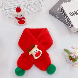 Detail of red plush Christmas scarf with cartoon reindeer and green pom-pom