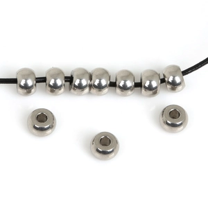 Flat round stainless steel spacer beads for DIY jewelry making on white background