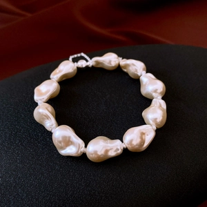 Detailed shot of baroque pearls with silver magnetic clasp on luxury velvet background