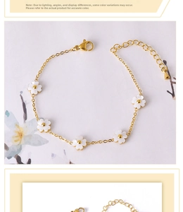 Detail of gold chain bracelet with five white shell flowers and adjustable lobster clasp