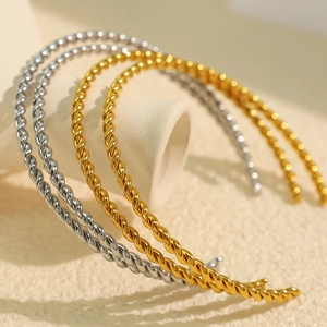 Modern twisted titanium steel open cuff bracelet in gold and silver metallic finishes