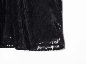 Close-up of black sequins on a halter dress showing high-density stitching and fabric detail