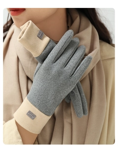 Detail of gray and beige wool blend gloves showing texture and fashion label on the cuff