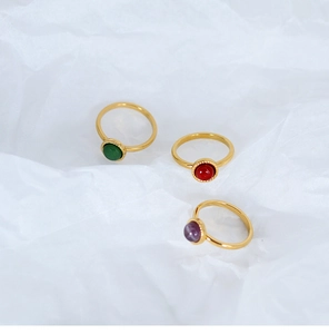 Detailed macro view of three 18K gold plated rings set with colorful natural gemstones
