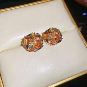 Macro shot of colorful mosaic square stud earrings with zircon crystals in gold plating