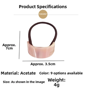 Detail showing marble texture acetate hair tie with France handmade gold engraving