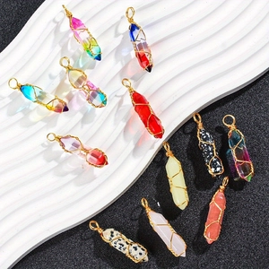 Set of hexagonal natural crystal stone pendants wrapped in golden wire on a minimalist base