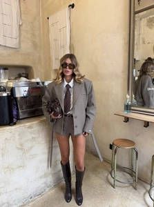 Detailed view of women's brown plaid blazer and shorts set with stylish vintage prep style
