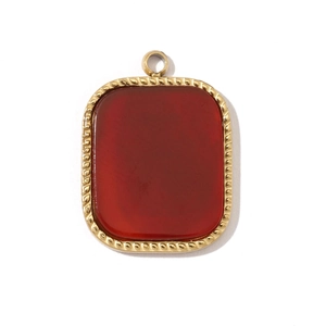Detail view of a square red natural stone pendant set in a golden woven metal frame