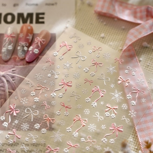Pink bow and white snowflake embossed nail stickers with delicate winter style textures