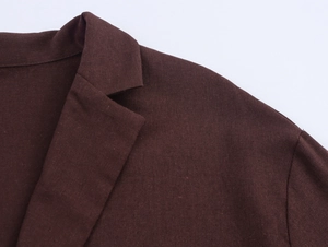 Detail of the chestnut brown blazer lapel showing fine linen texture and stitching