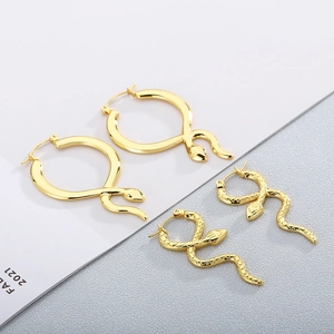 Detail of gold snake hoop earrings featuring smooth and textured scale finishes