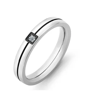 Minimalist silver stainless steel couple's ring with black inlay and a sparkling diamond