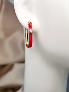 Macro shot of red enamel rectangular earrings with gold trim and tiny zircon inlay