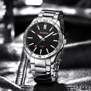 Detail of silver stainless steel watch with black dial and red second hand