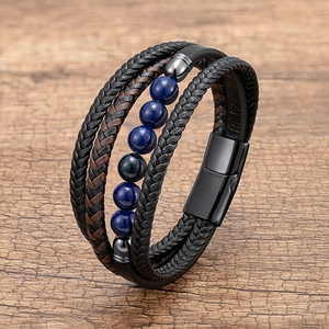 Macro shot of multilayered leather cord bracelet with blue beads and magnetic metal clasp