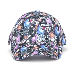 Detailed view of unicorn and sun prints on a black and white tie-dye baseball cap fabric