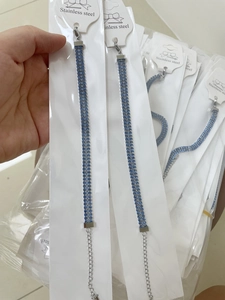 Detailed shot of three-row blue rhinestone bracelet with stainless steel silver chain