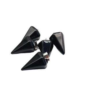 Polished natural black agate hexagonal cone pendants with silver metal bails on white background