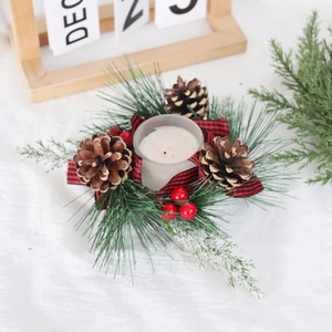 Macro detail of Christmas wreath candle holder with pine needles, cones and red berries