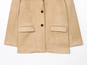 Detail of camel suede jacket featuring matte texture and dark brown buttons with pockets