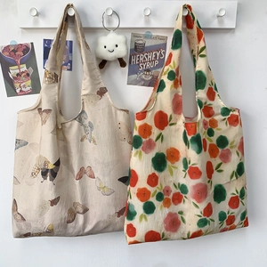 Detail of canvas tote bags with butterfly and floral prints hanging in a retro setting