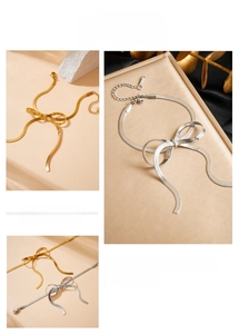 Detail of gold and silver bow-knot snake chain bracelets with adjustable lobster clasp