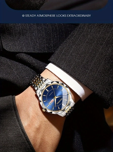 Detail of men's steel watch with blue sunray dial and gold-silver link bracelet