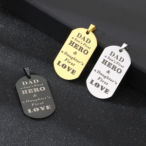 Black, gold and silver stainless steel Dad Hero pendants on dark textured background