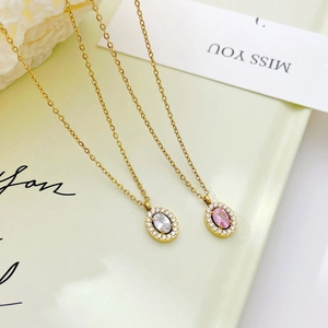 Elegant gold zircon hollow pendant necklace on a cream tray with floral decor