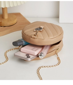 Internal view of semi-circle chain bag showing phone and lipstick storage capacity