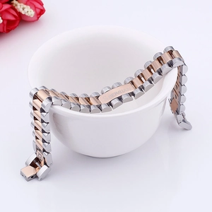 Detail of silver and rose gold stainless steel watch band bracelet with engraved bar