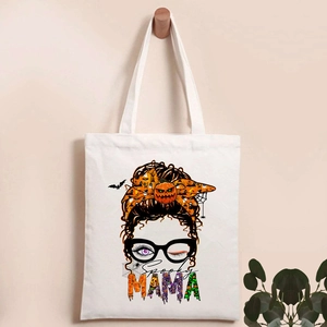 Halloween canvas tote bag with Spooky Mama print and cartoon pumpkin graphic